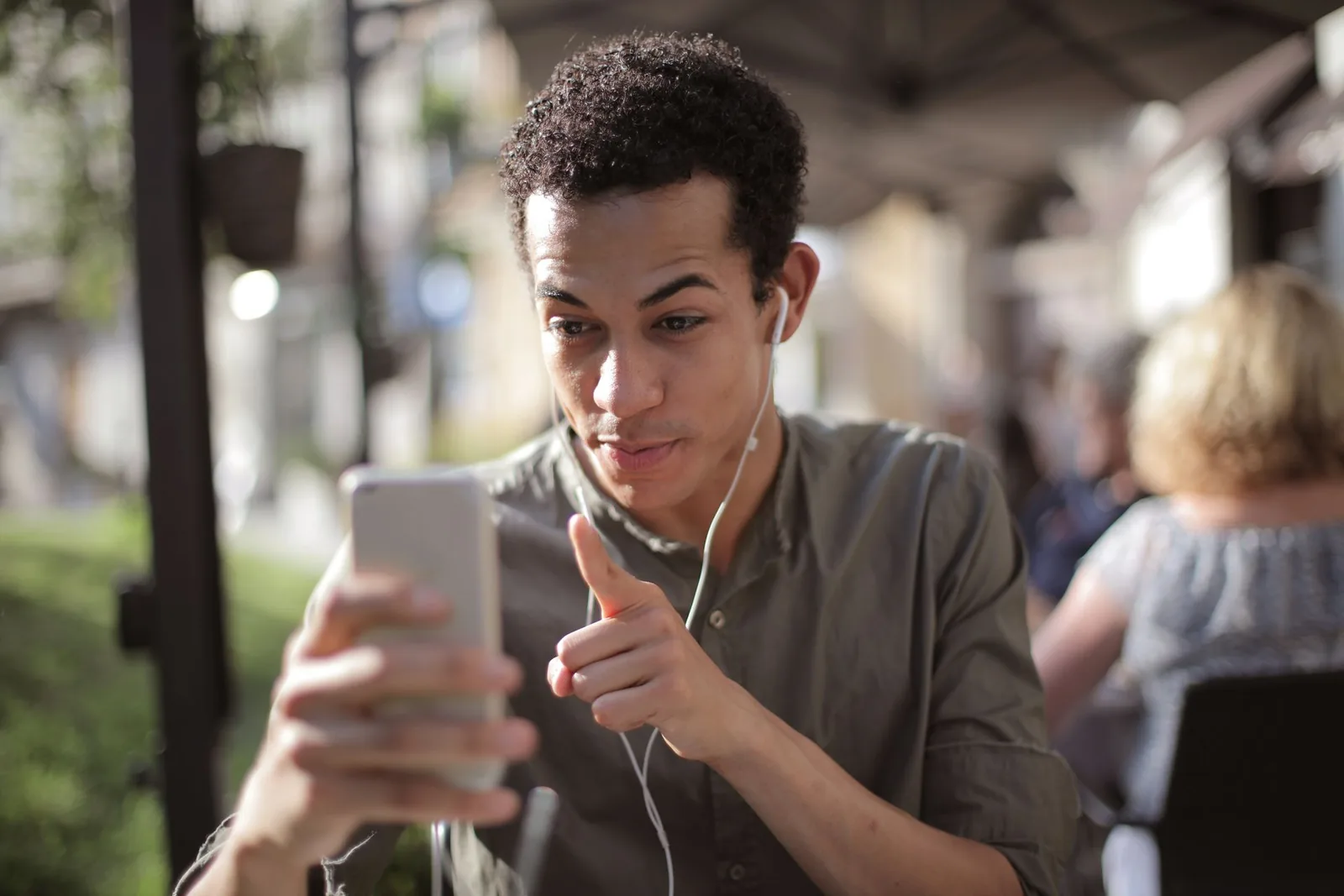 A young man talking with someone on his phone.